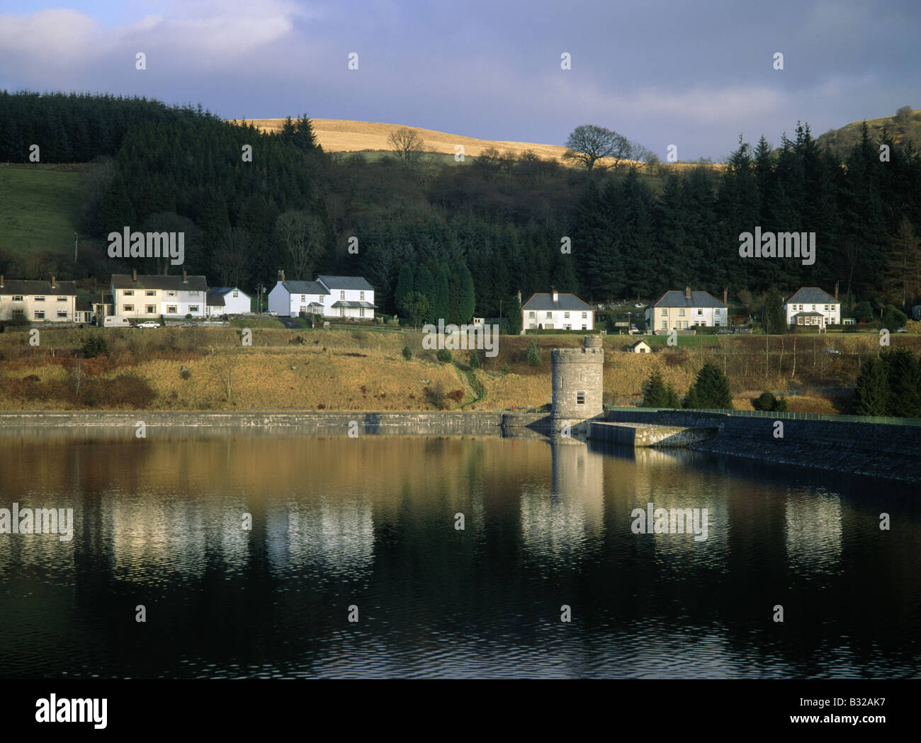 Brecon beacons Houses by reservoir Reflections in water Wall Tower Light on cornfield LLWYNONN POWYS WALES Stock Photo