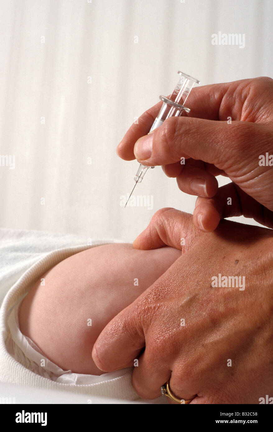 vaccine going into baby s leg for MMR immunisation Stock Photo