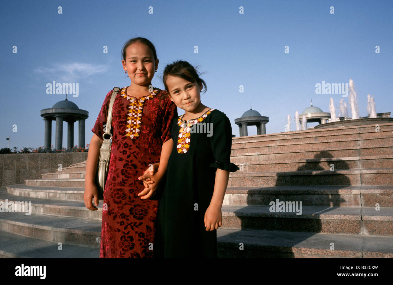 May 7, 2006 - Two little local ladies wearing the traditional Turkmen national costume (Kurta) at Independence Park in Ashgabat. Stock Photo