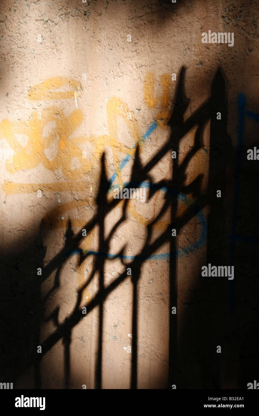 abstract gate fence shadow graffiti wall outdoors Stock Photo