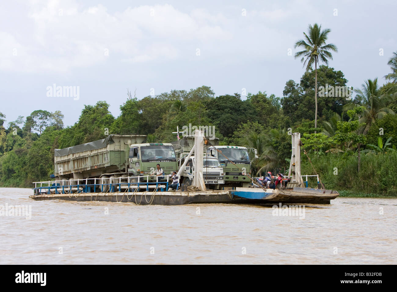 Transporting lorries along the Kinabatangan River Sabah Borneo Stock Photo