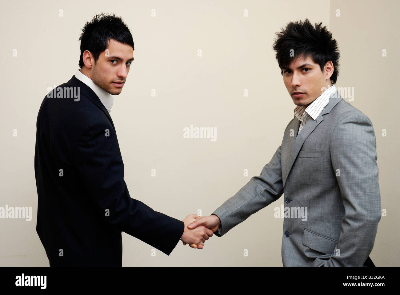 Two young businessmen shaking hands Stock Photo