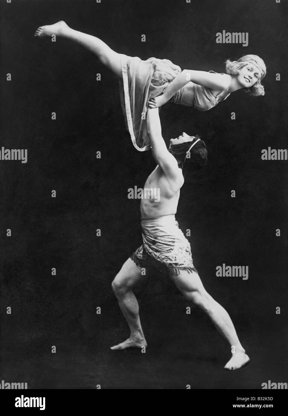 Male dancer holding female dancer aloft Stock Photo