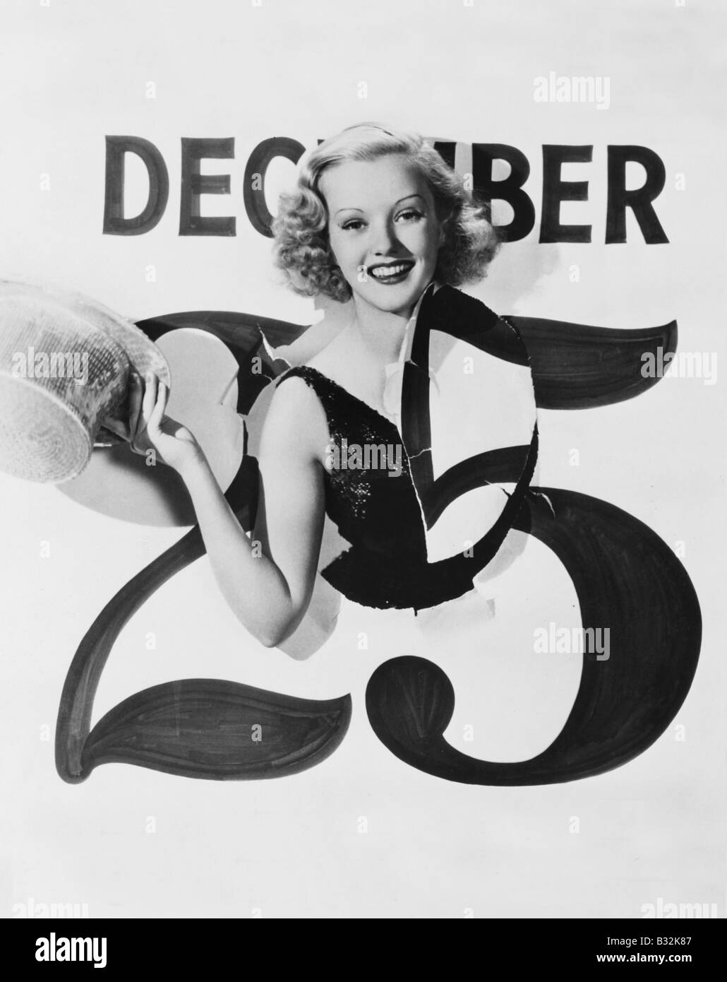 Woman bursting through calendar on Christmas day Stock Photo