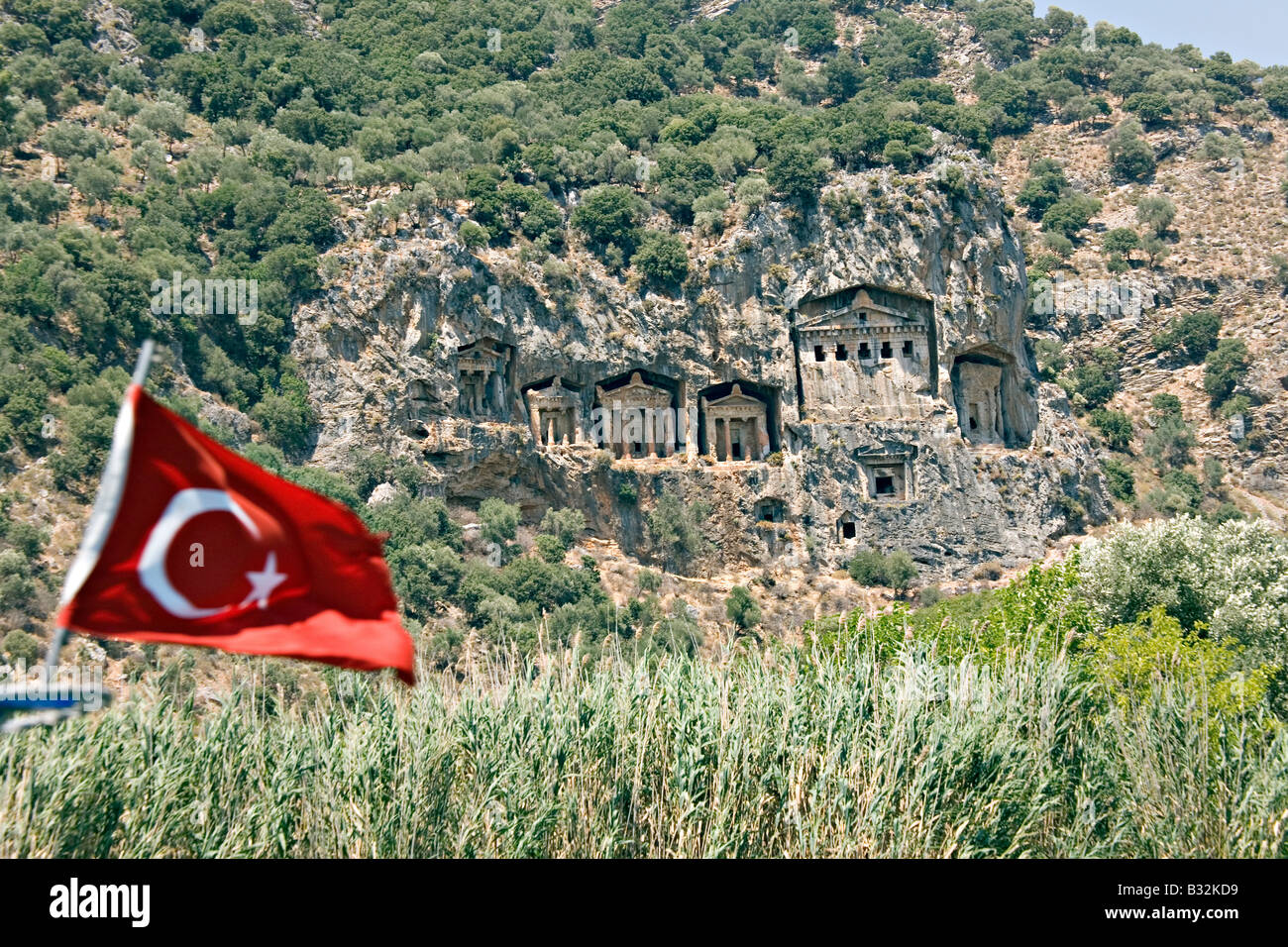 Lycian rock tombs with turkish flag Stock Photo