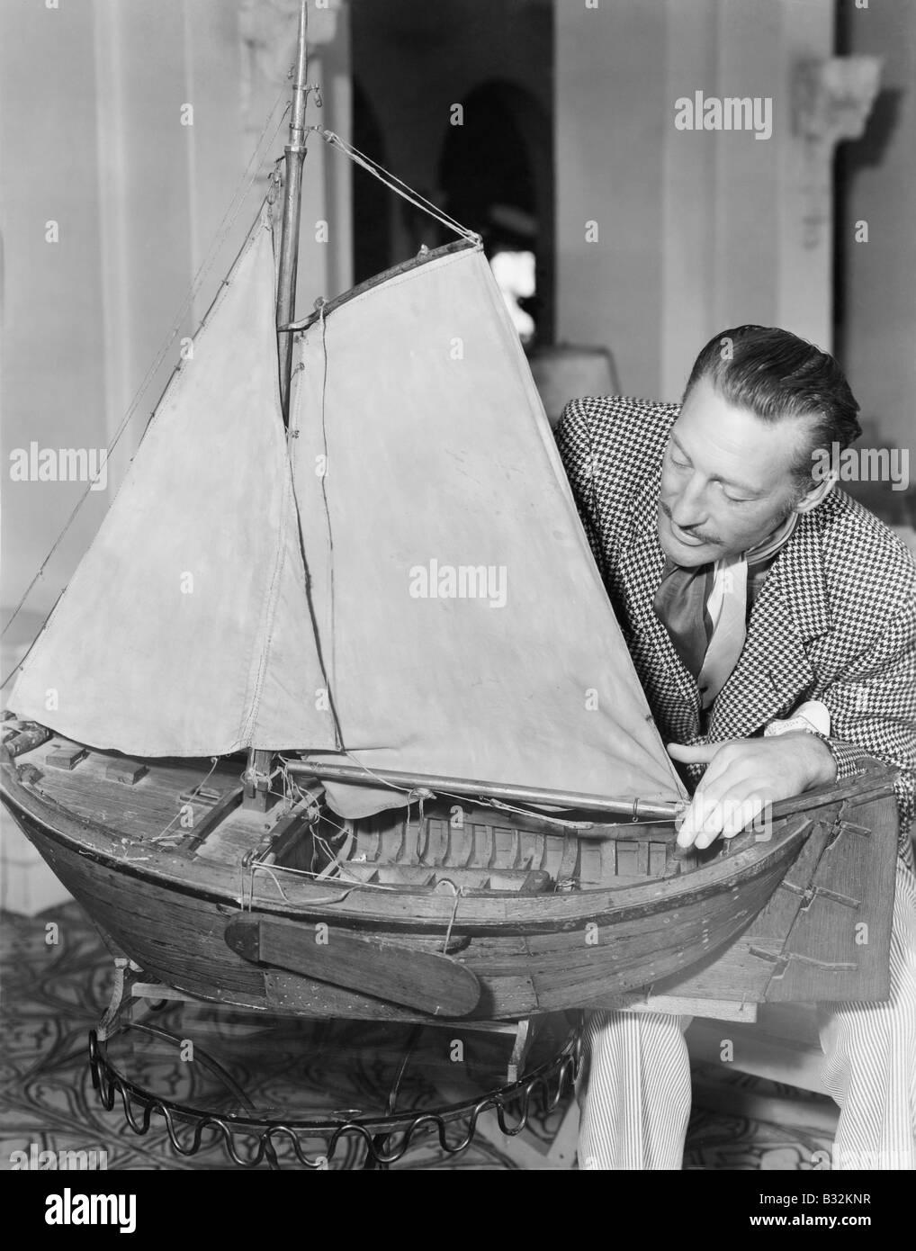 Man with model ship Stock Photo