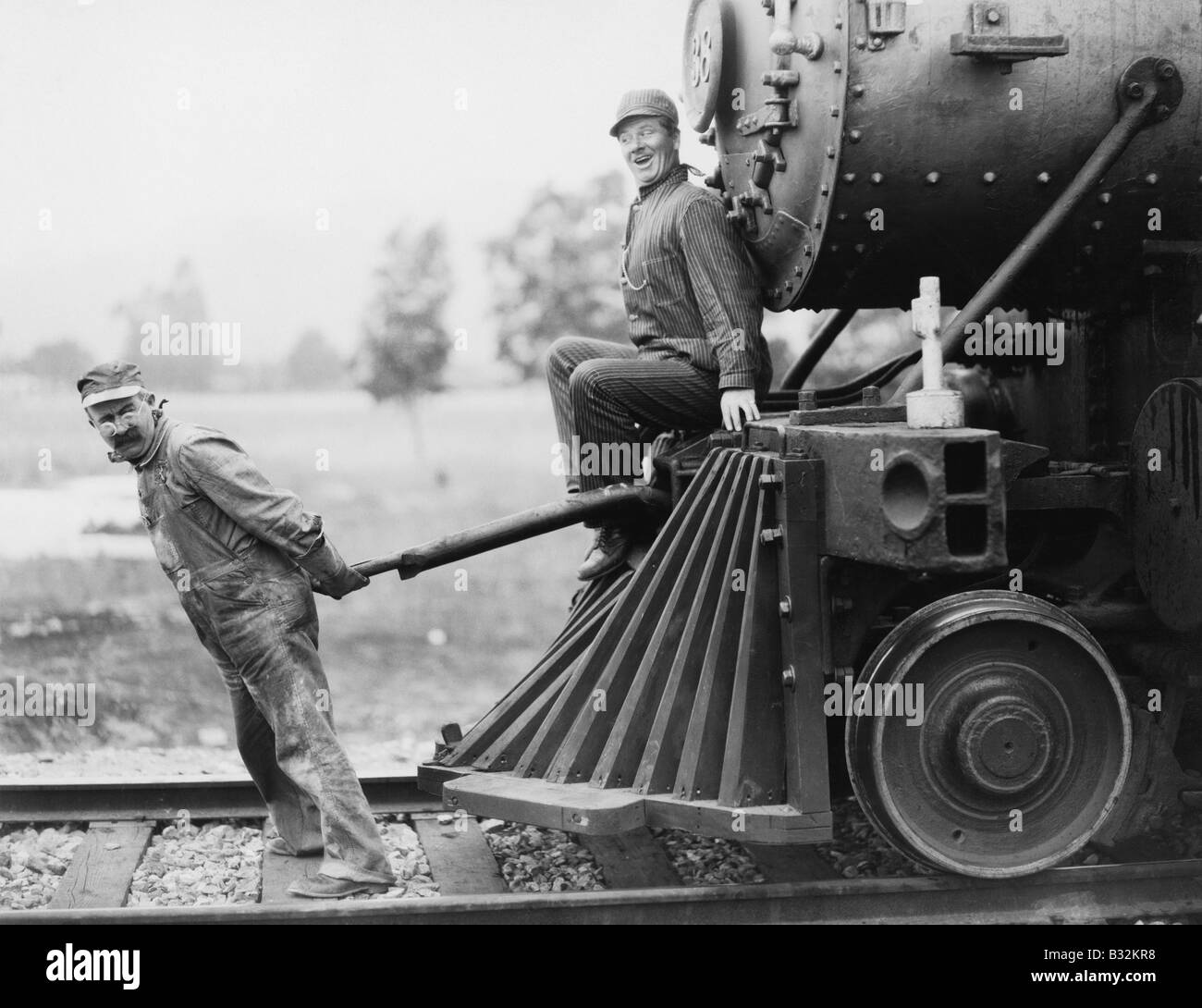 Engineers pulling train engine Stock Photo Alamy