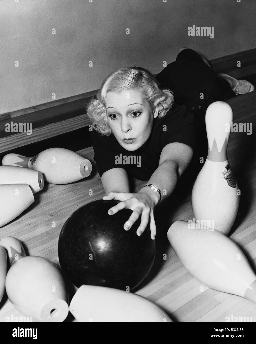 Woman having bowling accident Stock Photo