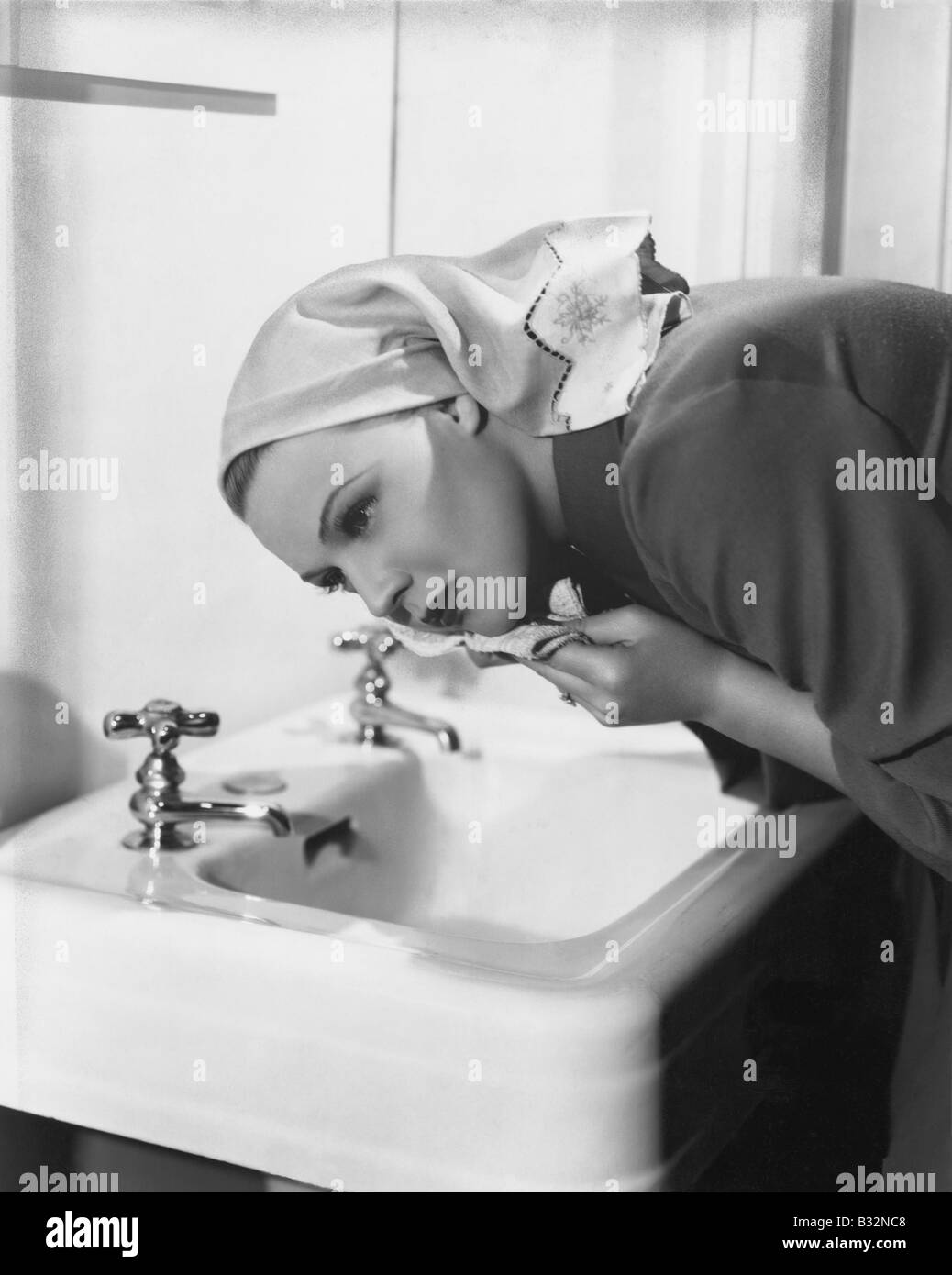 Woman washing face over sink Stock Photo Alamy