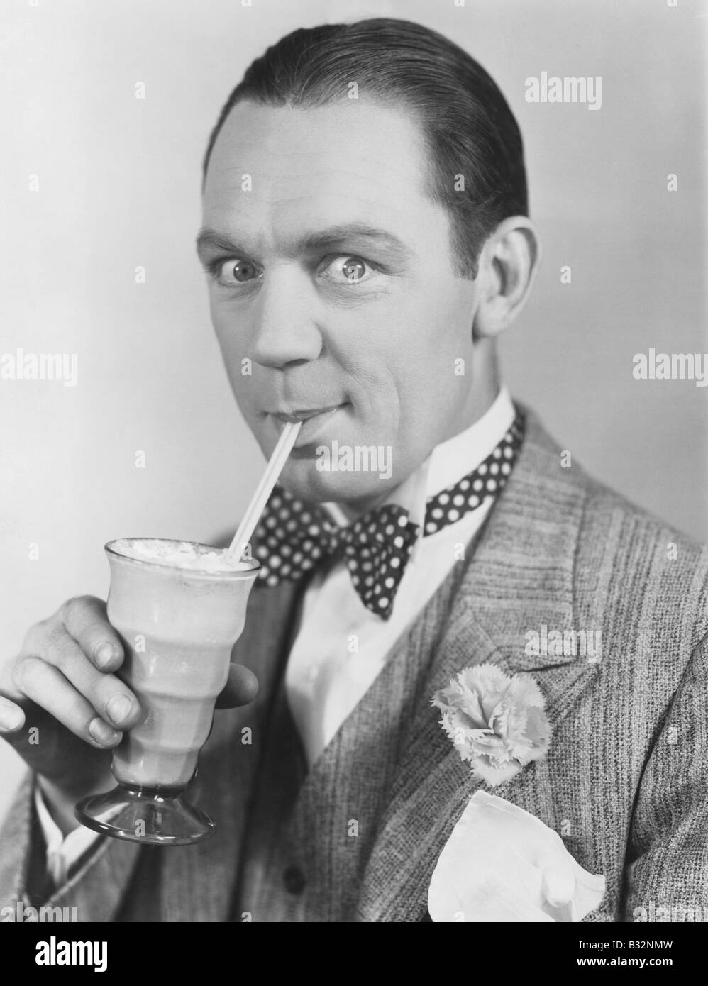Portrait of man drinking through straw Stock Photo
