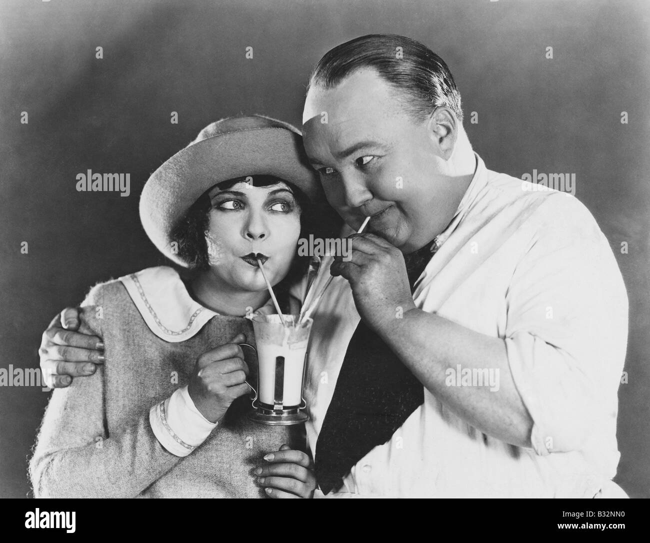 Couple drinking beverage with straw Stock Photo