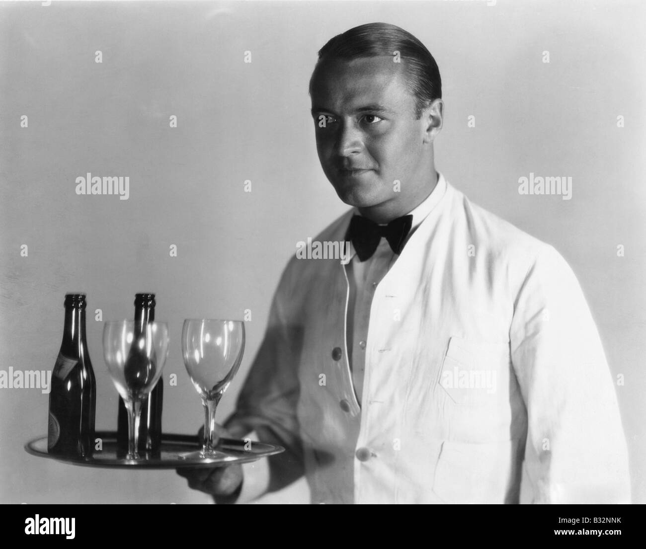 Waiter with beverages on tray Stock Photo