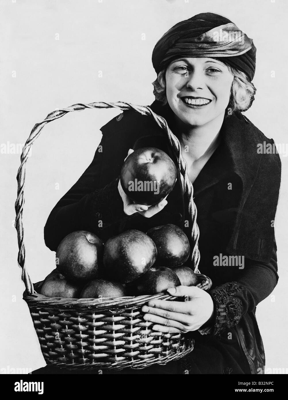 Portrait of woman with basket of apples Stock Photo - Alamy