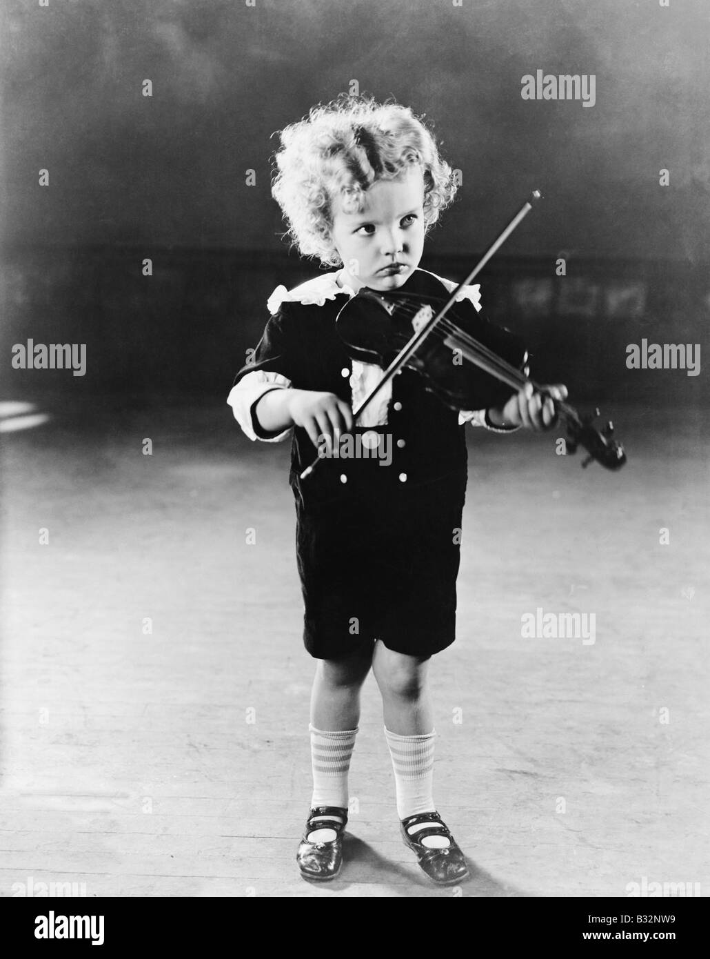Portrait of little boy playing violin Stock Photo