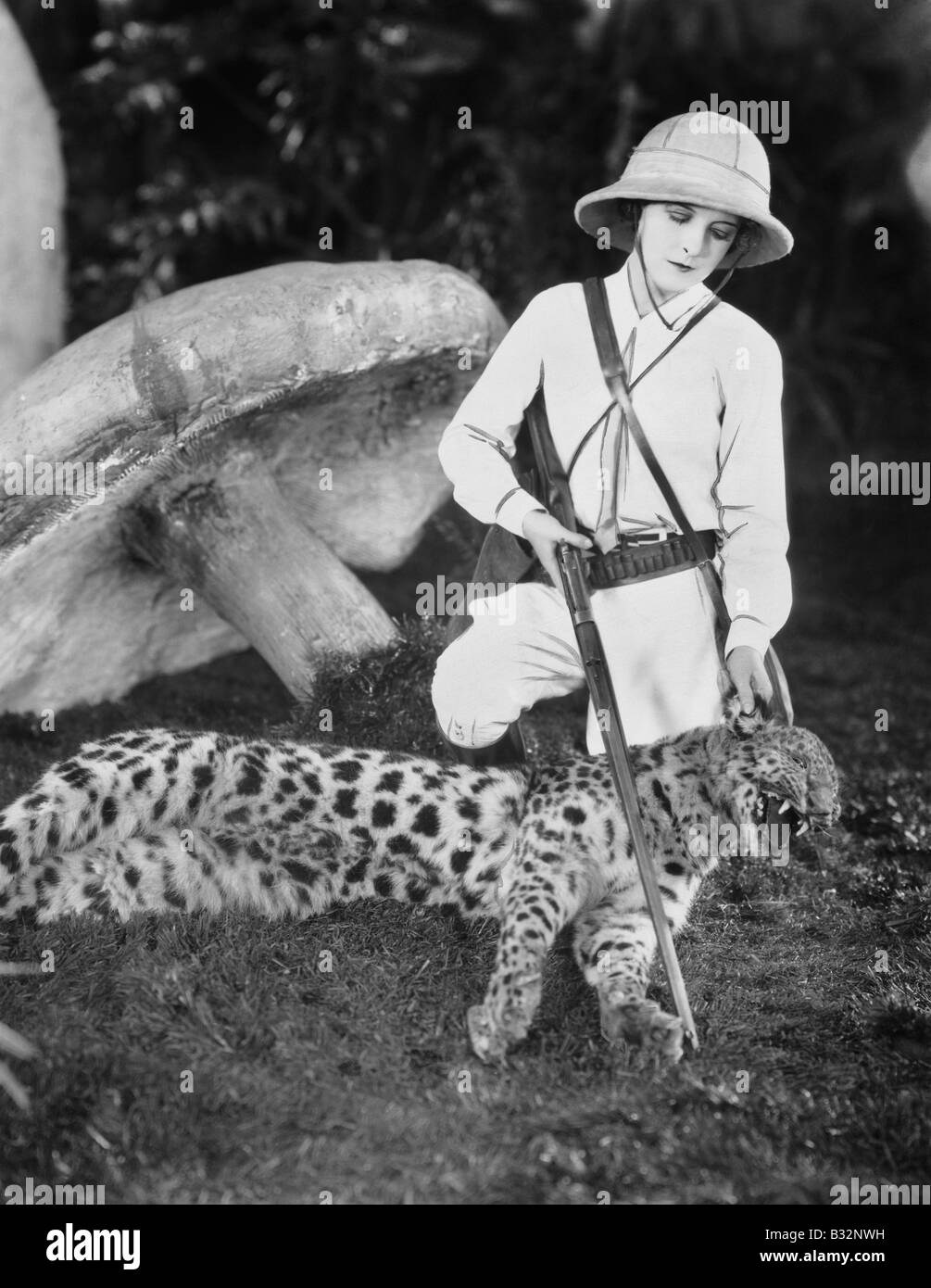 Female hunter with dead leopard Stock Photo