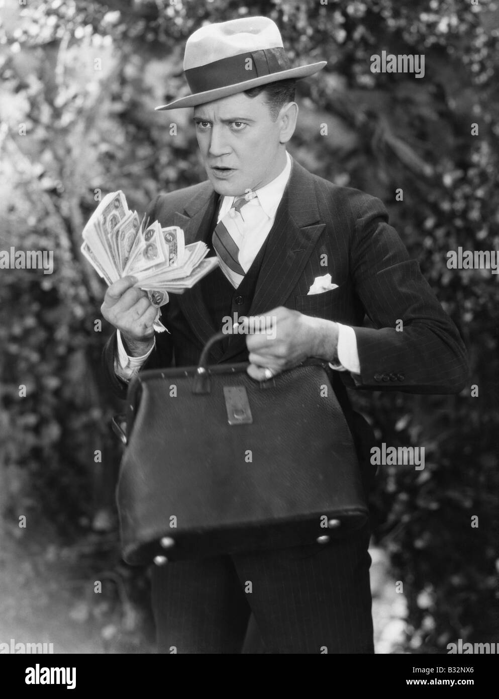 Man with bag full of cash Stock Photo