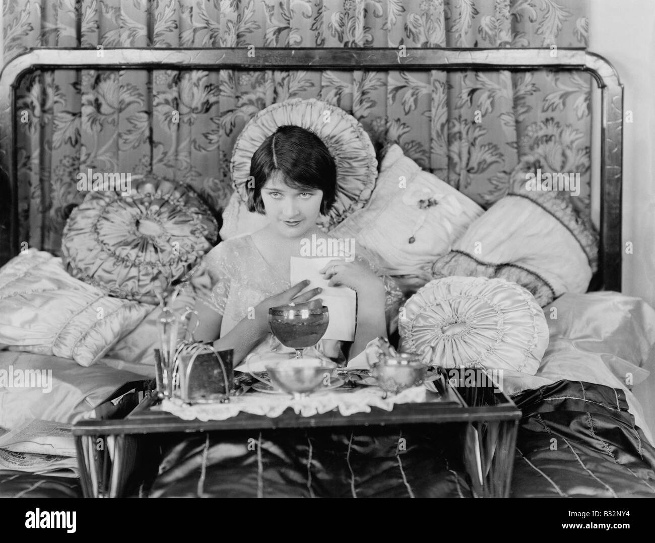 Woman having breakfast in bed Stock Photo