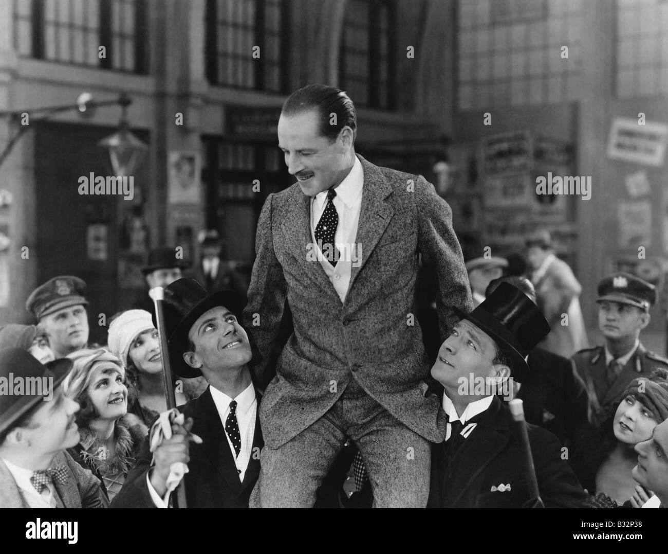 Man carried on shoulders above crowd Stock Photo Alamy