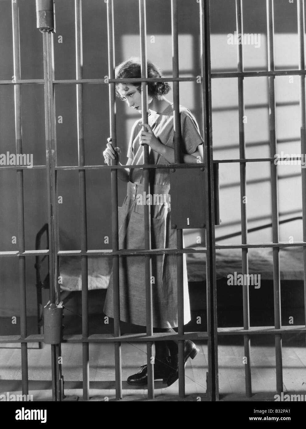 Woman in jail cell Stock Photo Alamy