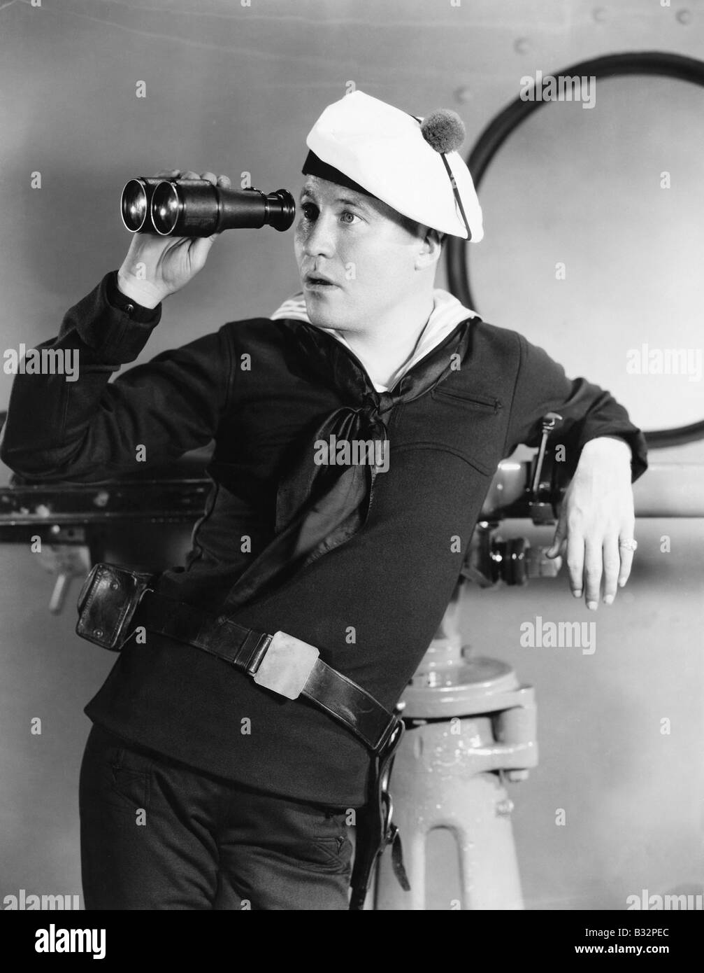 Portrait of sailor looking through binoculars Stock Photo