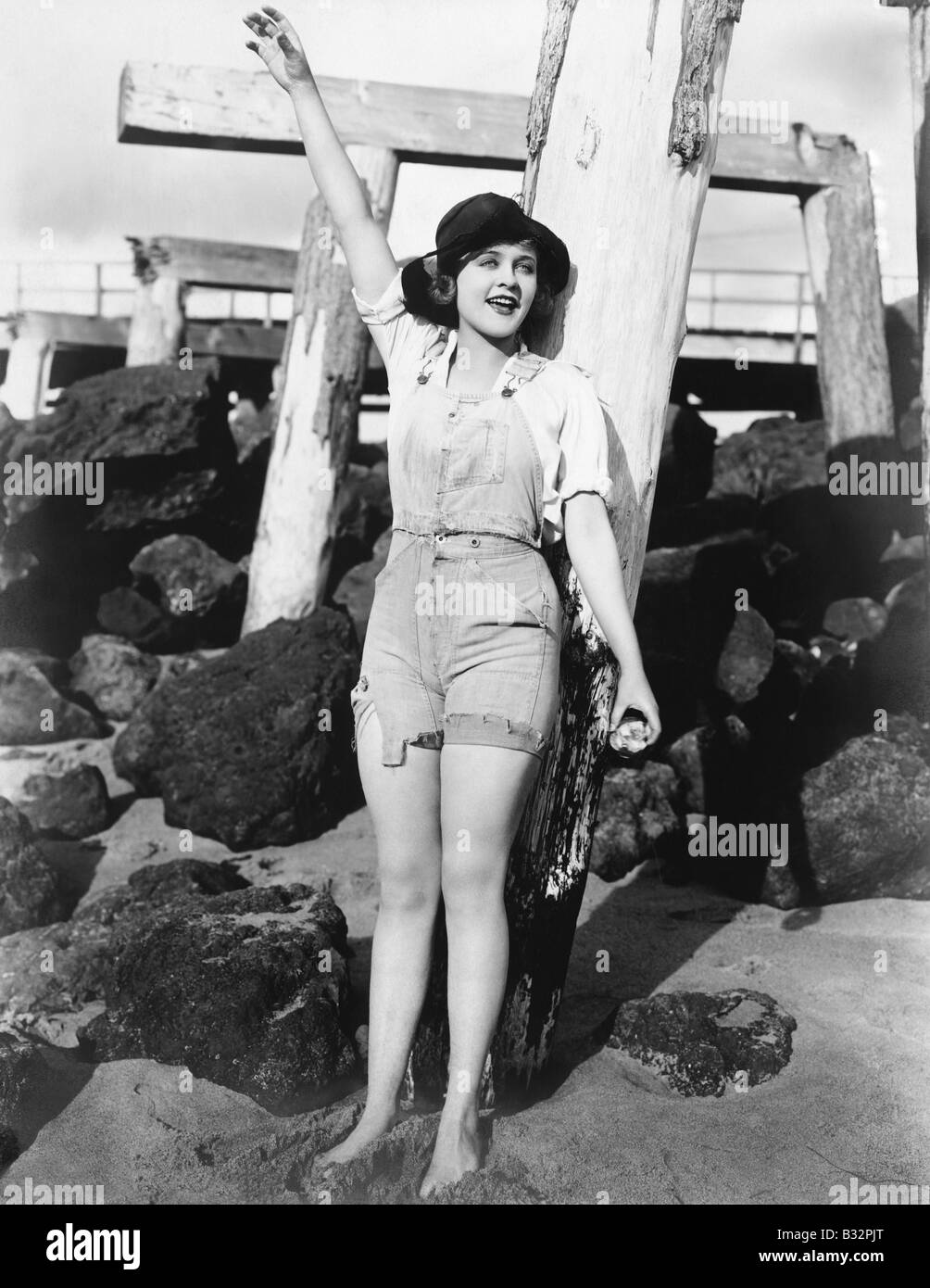 Woman with pilings at beach Stock Photo