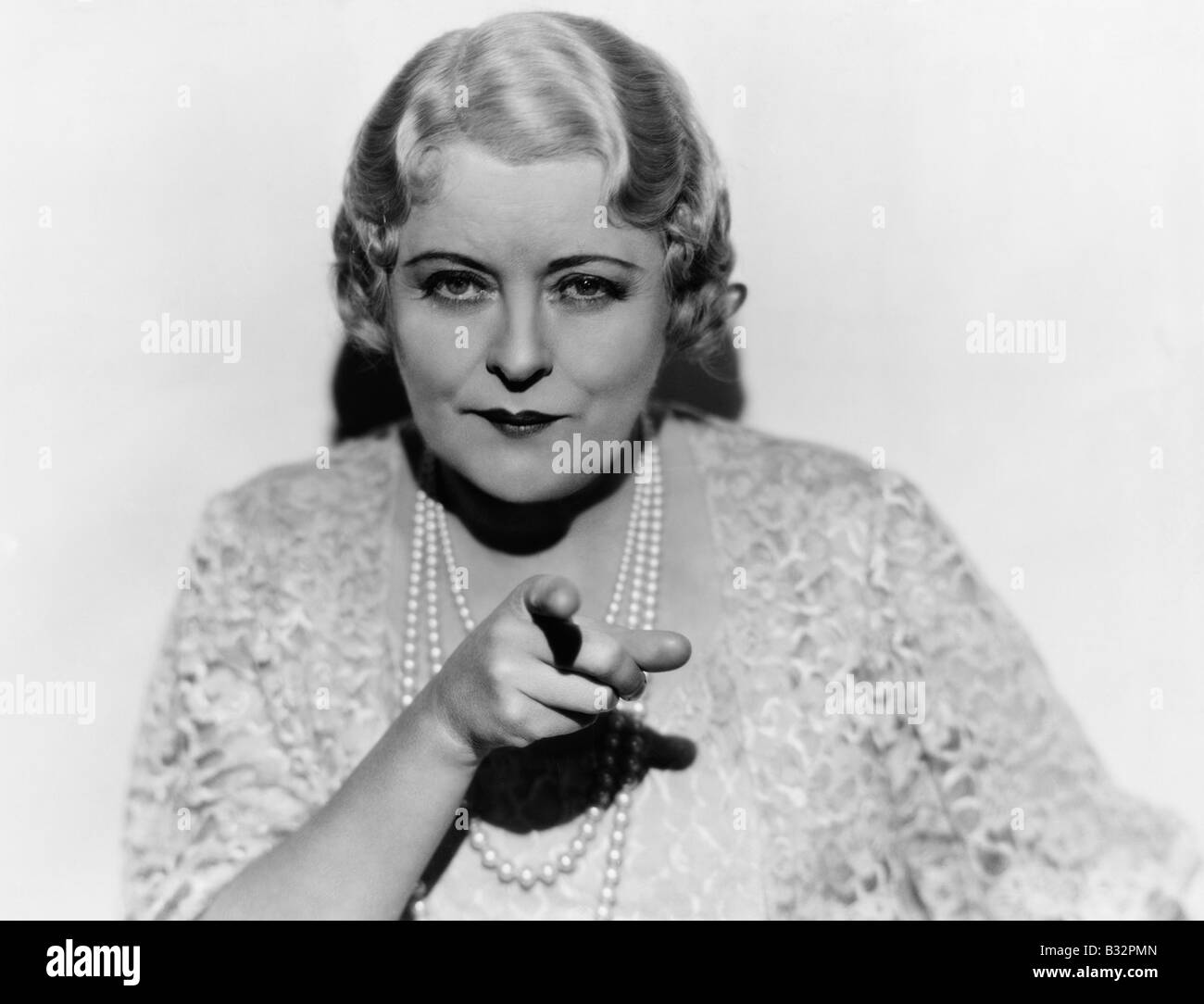 Portrait of mature woman pointing finger Stock Photo