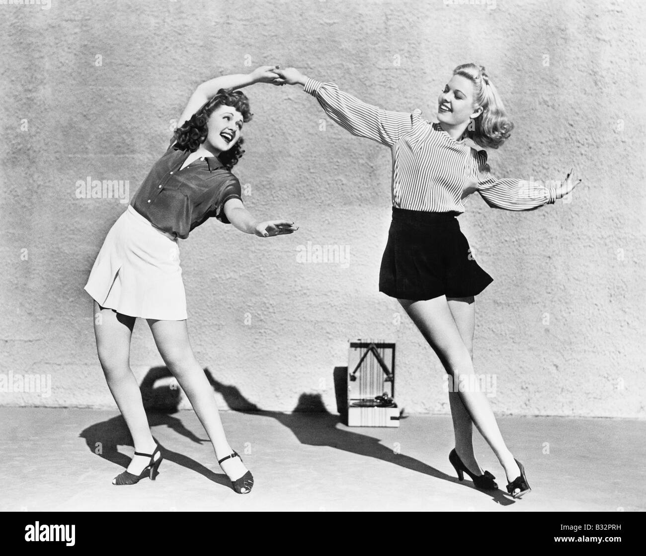 Two women dancing outside Stock Photo