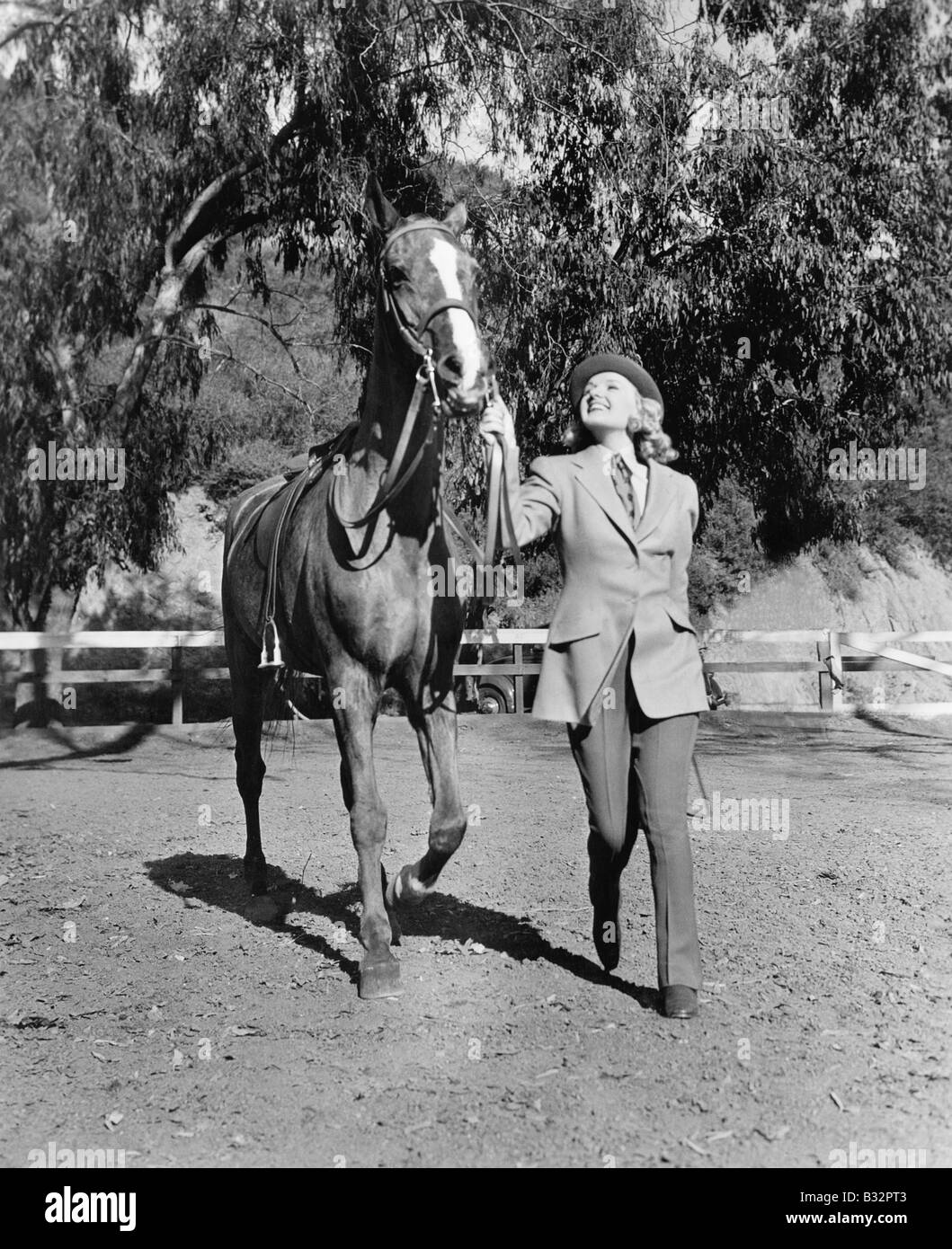 Woman leading horse Stock Photo