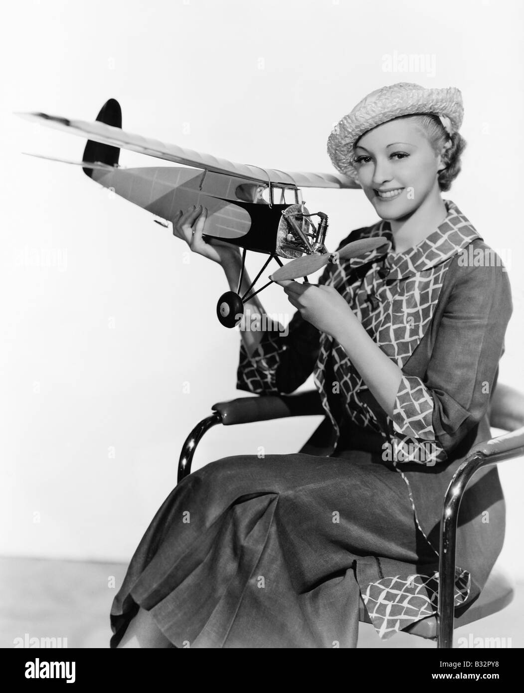 Woman holding model airplane Stock Photo