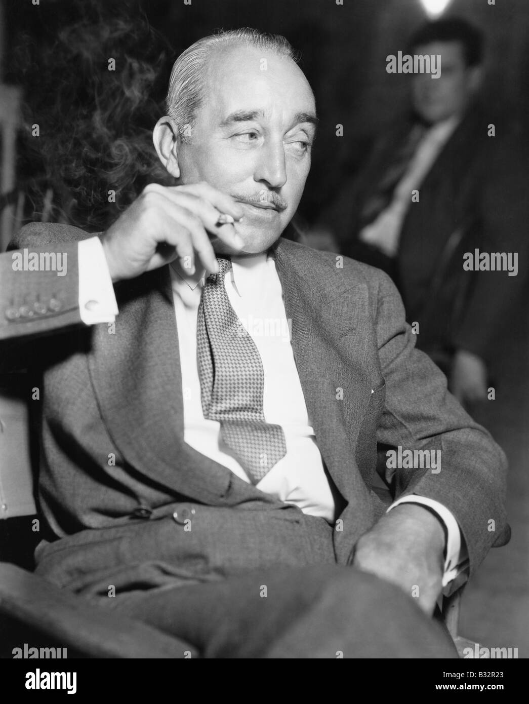 Elegant Man Sitting And Smoking A Cigarette Stock Photo Alamy elegant-man-sitting-and-smoking-a-cigarette-stock-photo-alamy