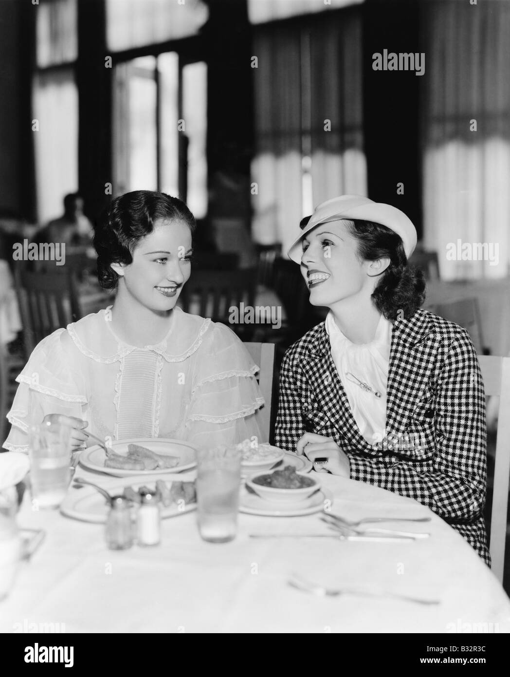 Two women sitting together in a restaurant Stock Photo - Alamy