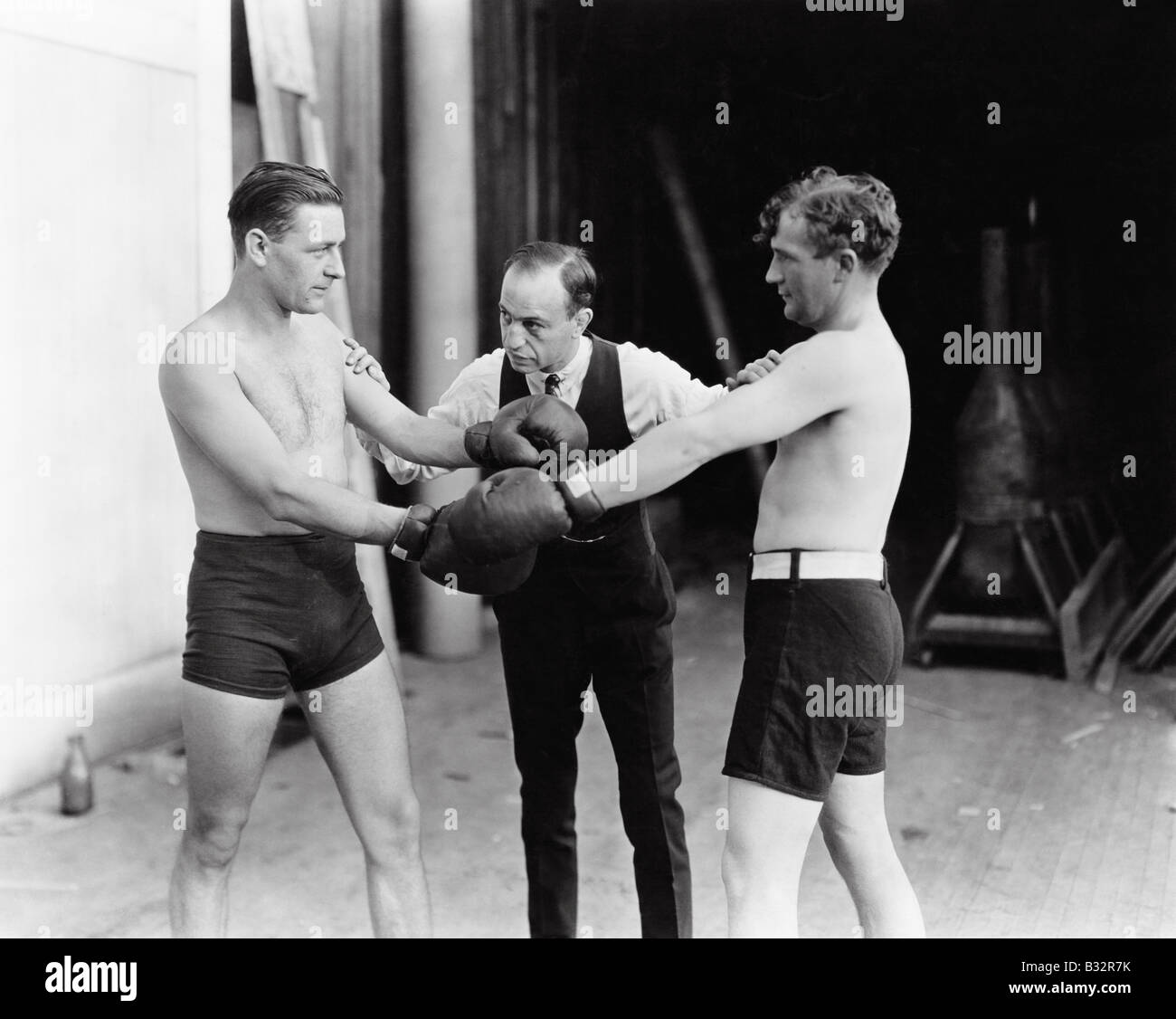 Reply Boxers Two boxers and a referee Stock Photo - Alamy
