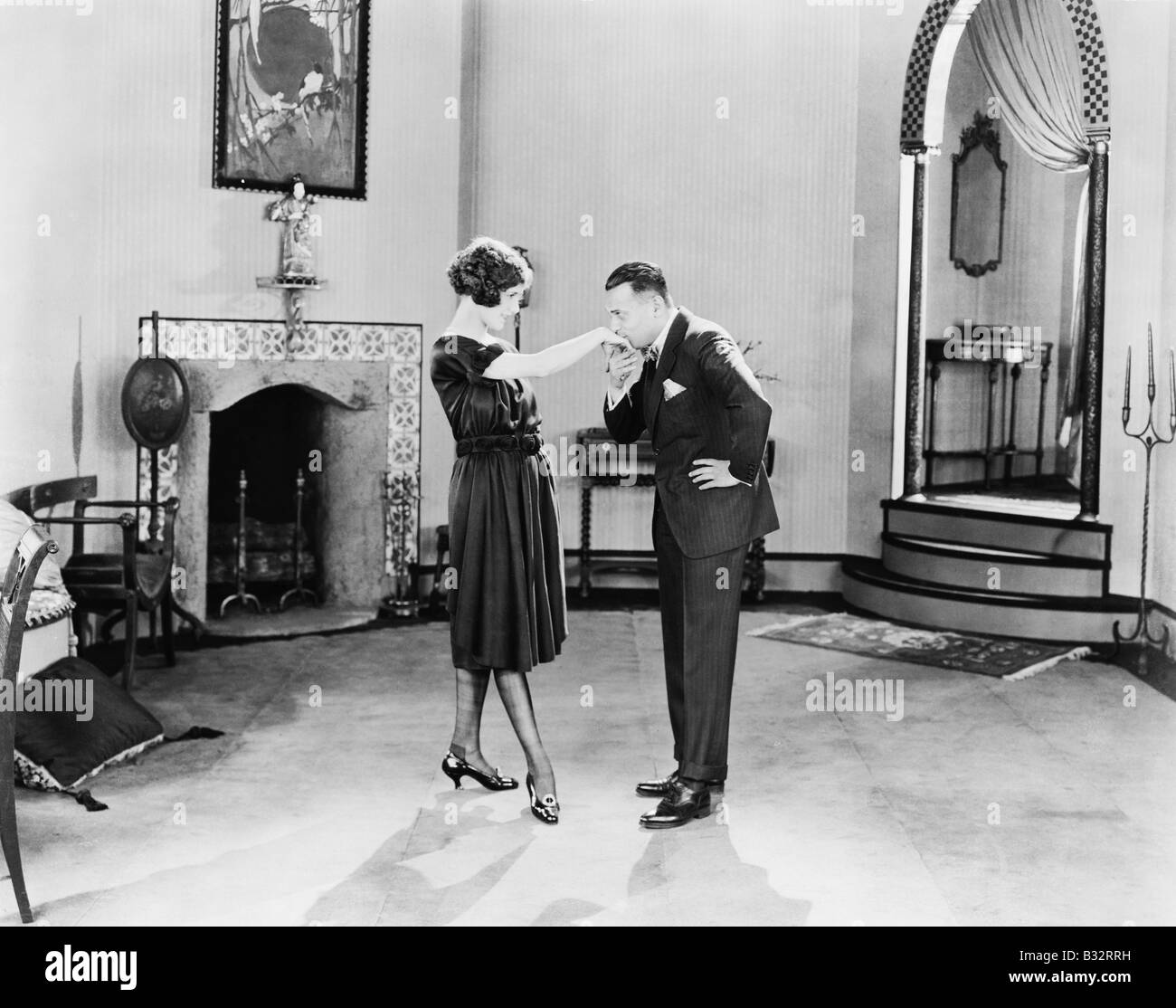 Profile of a man kissing a young woman's hand Stock Photo - Alamy