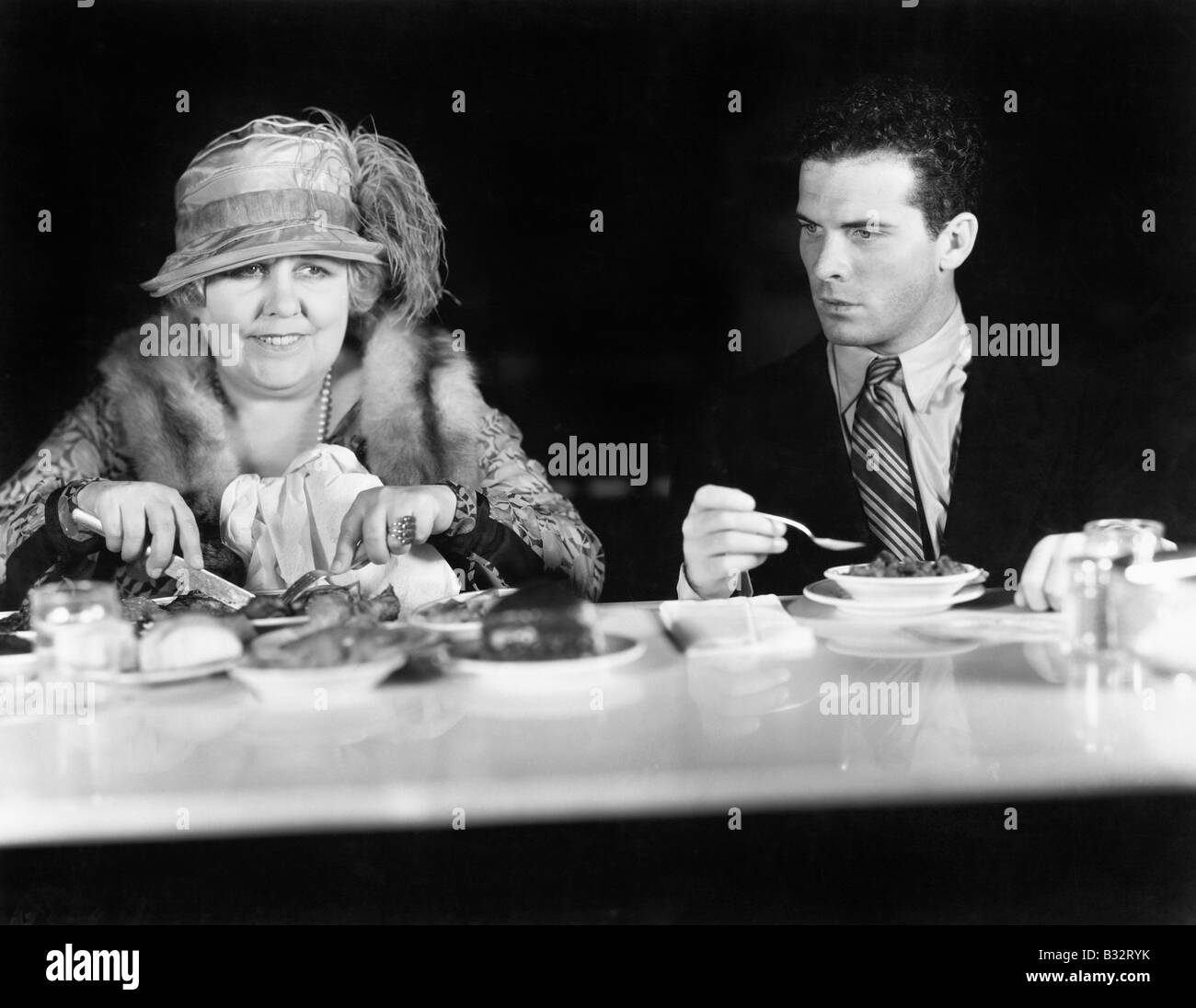 Woman and young man sitting at a coffee counter Stock Photo