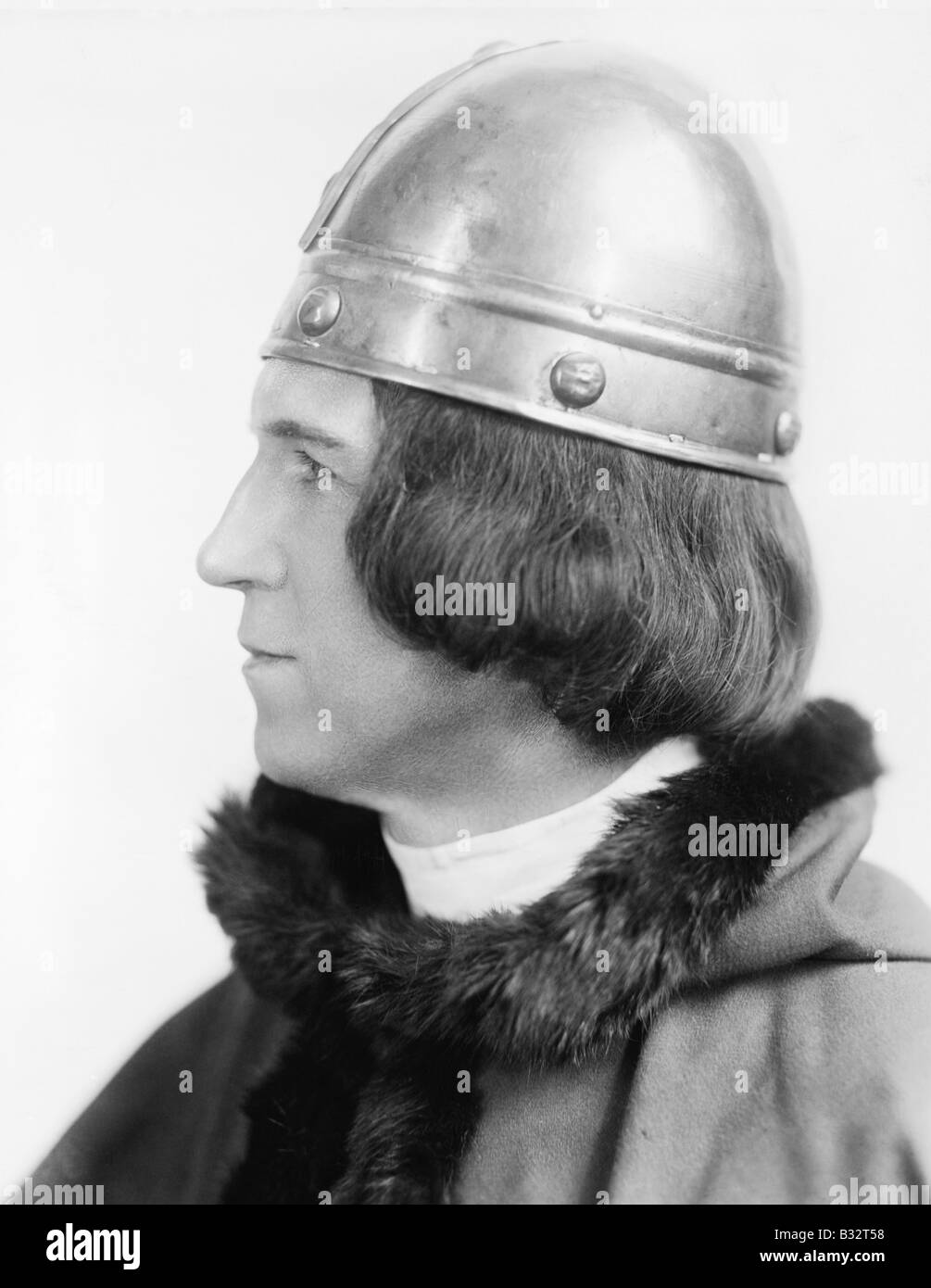 Portrait of a man in costume and a helmet looking away Stock Photo