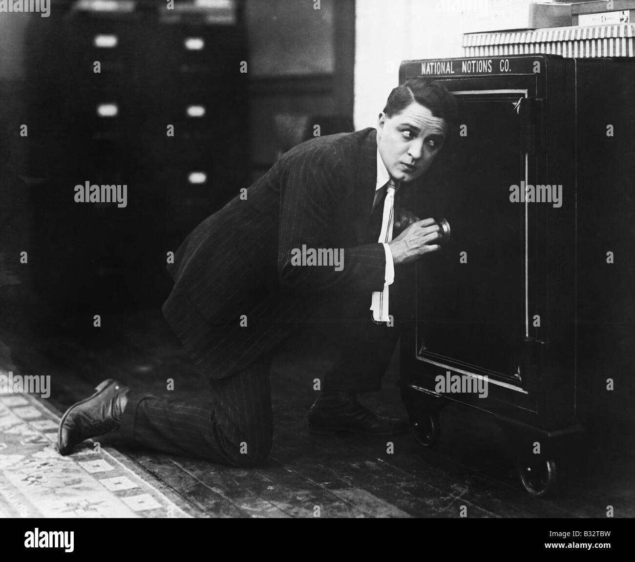 Profile of a man opening the door of a safe Stock Photo