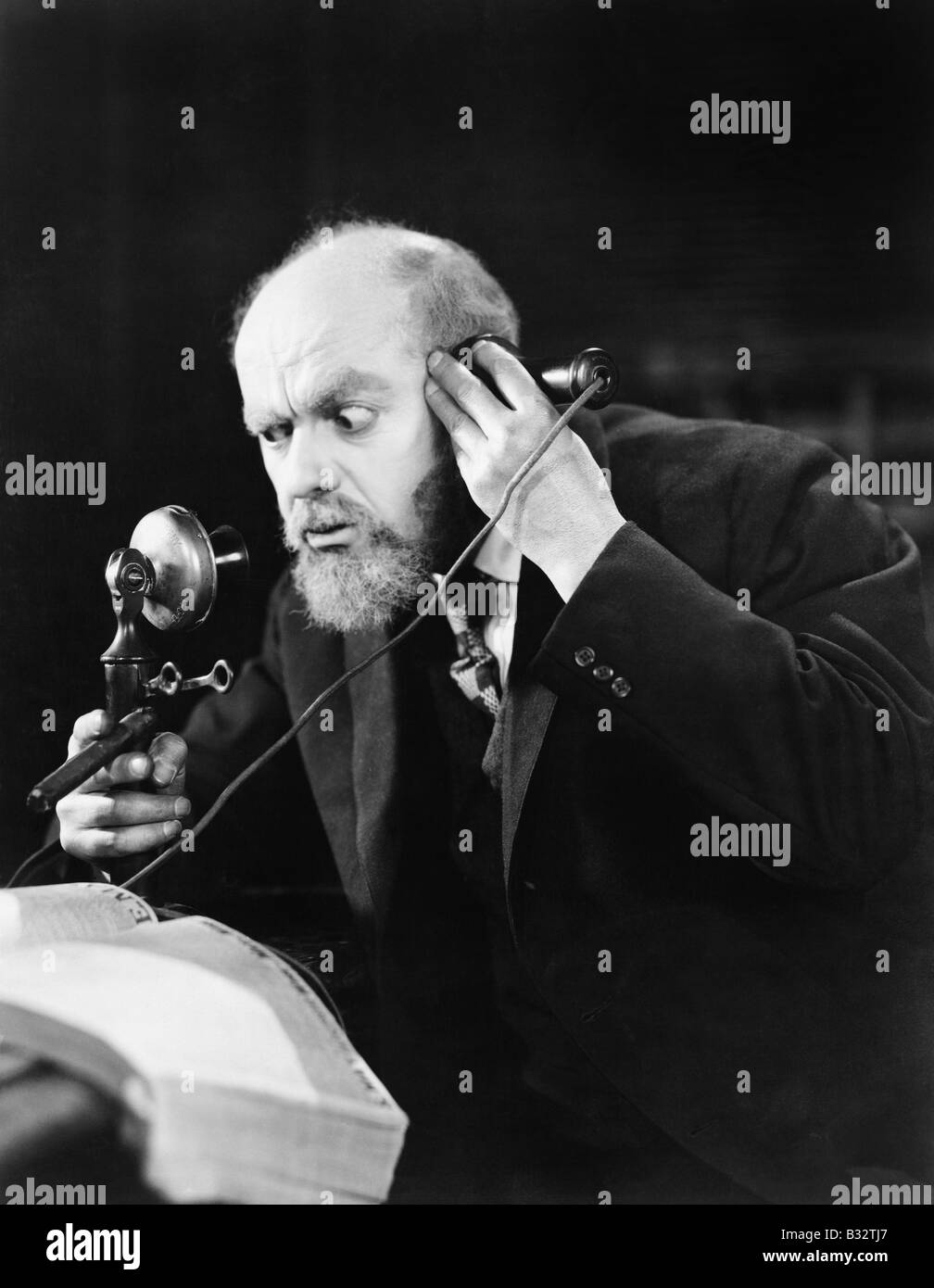 Man talking on the telephone looking intense Stock Photo