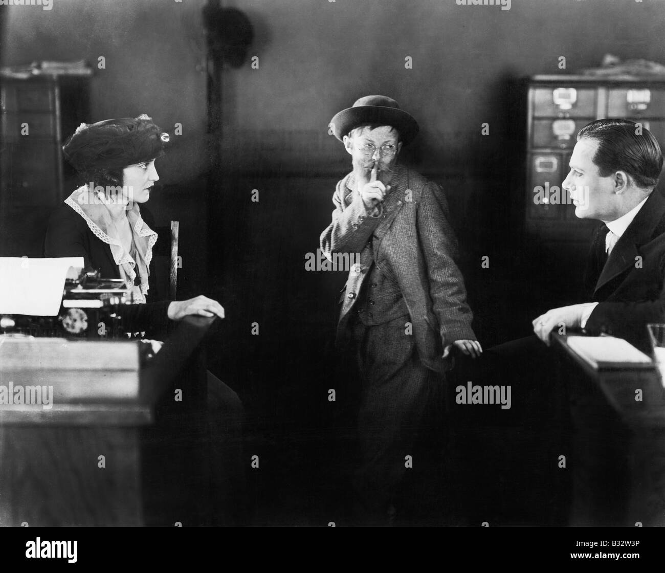 Child looking at two grownups asking to keep a secret Stock Photo