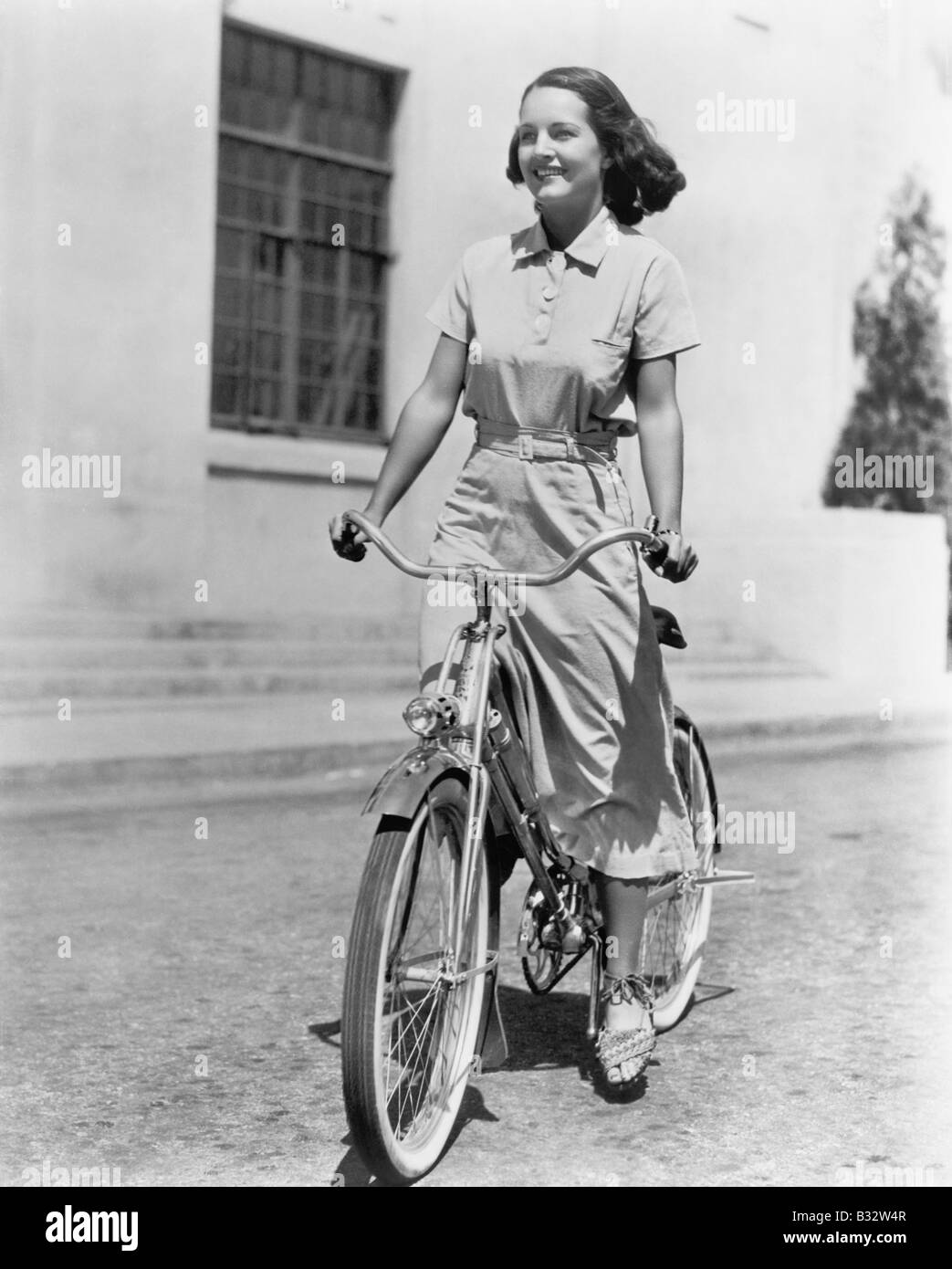Young woman riding her bike Stock Photo