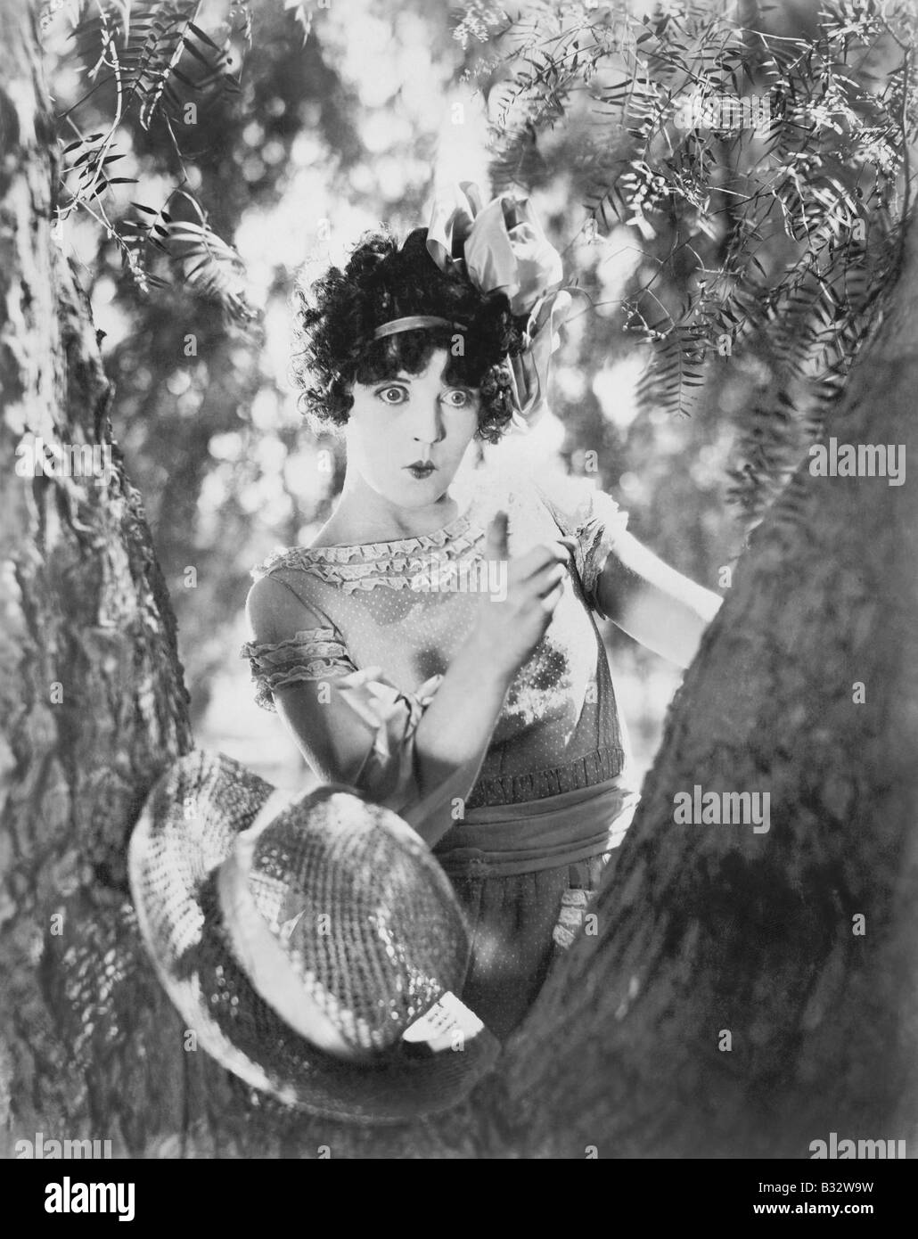 Young woman scolds a knotty tree Stock Photo