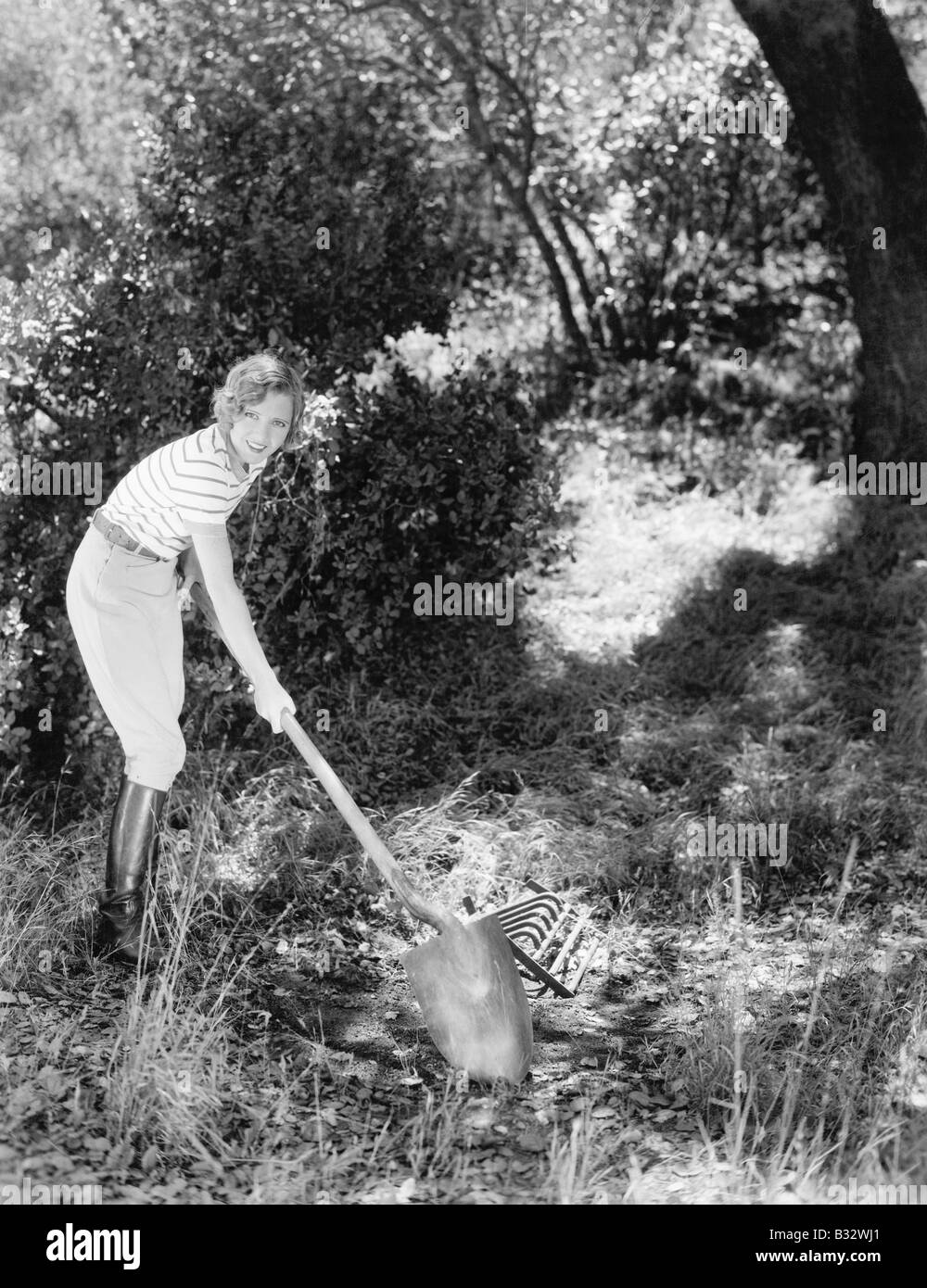 Young woman in a garden doing gardening Stock Photo