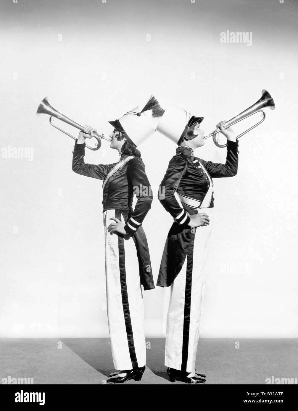 Two women in a toy soldier uniforms with trumpets Stock Photo
