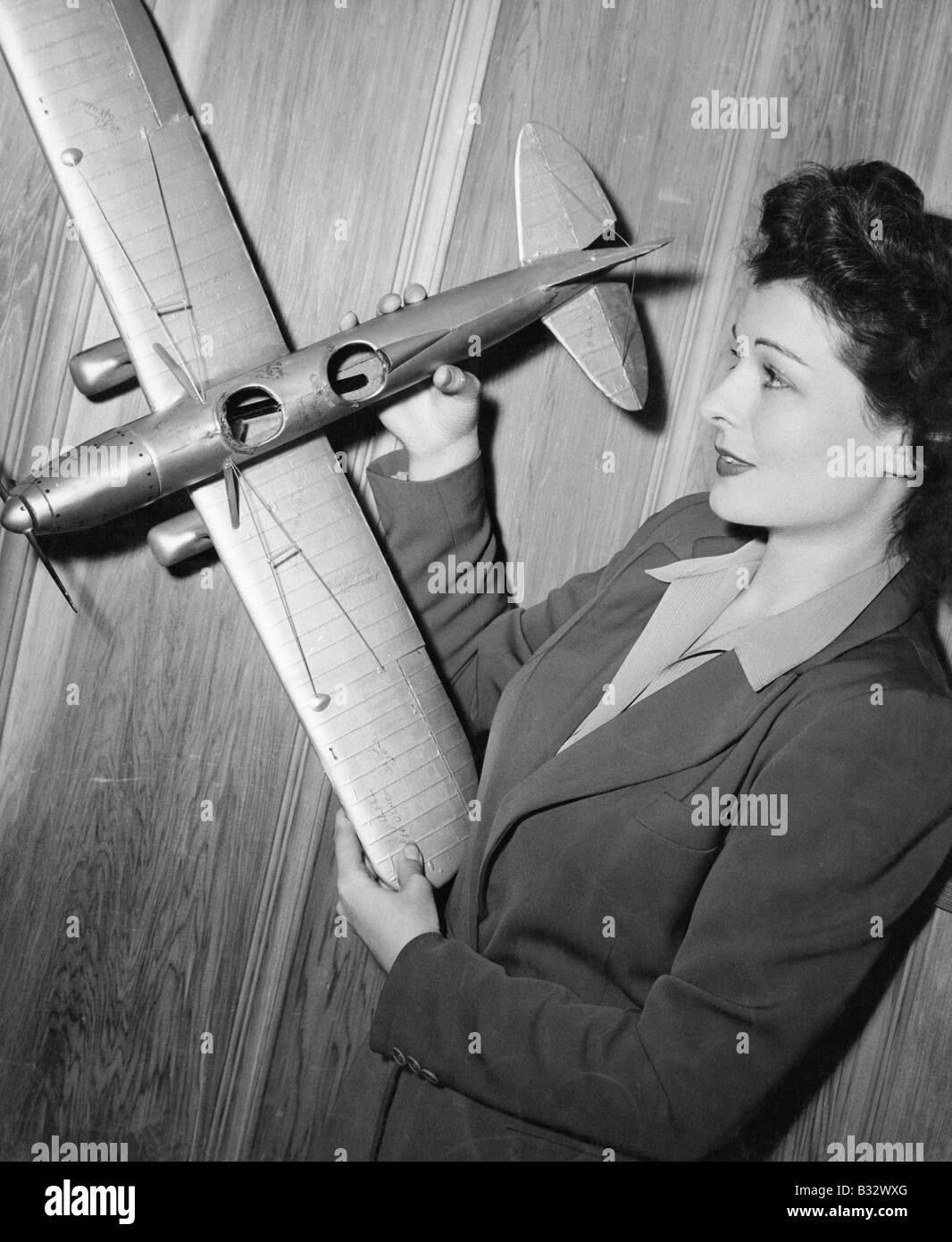 Young woman holding a model plane Stock Photo