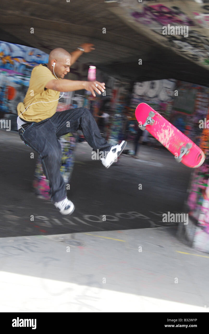 Skateboard graffiti urban inner city grime stunt jump leap sport Stock Photo