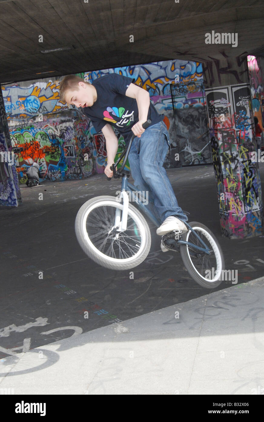BMX stunt bike jump trick urban sport park ramp teenagers Stock