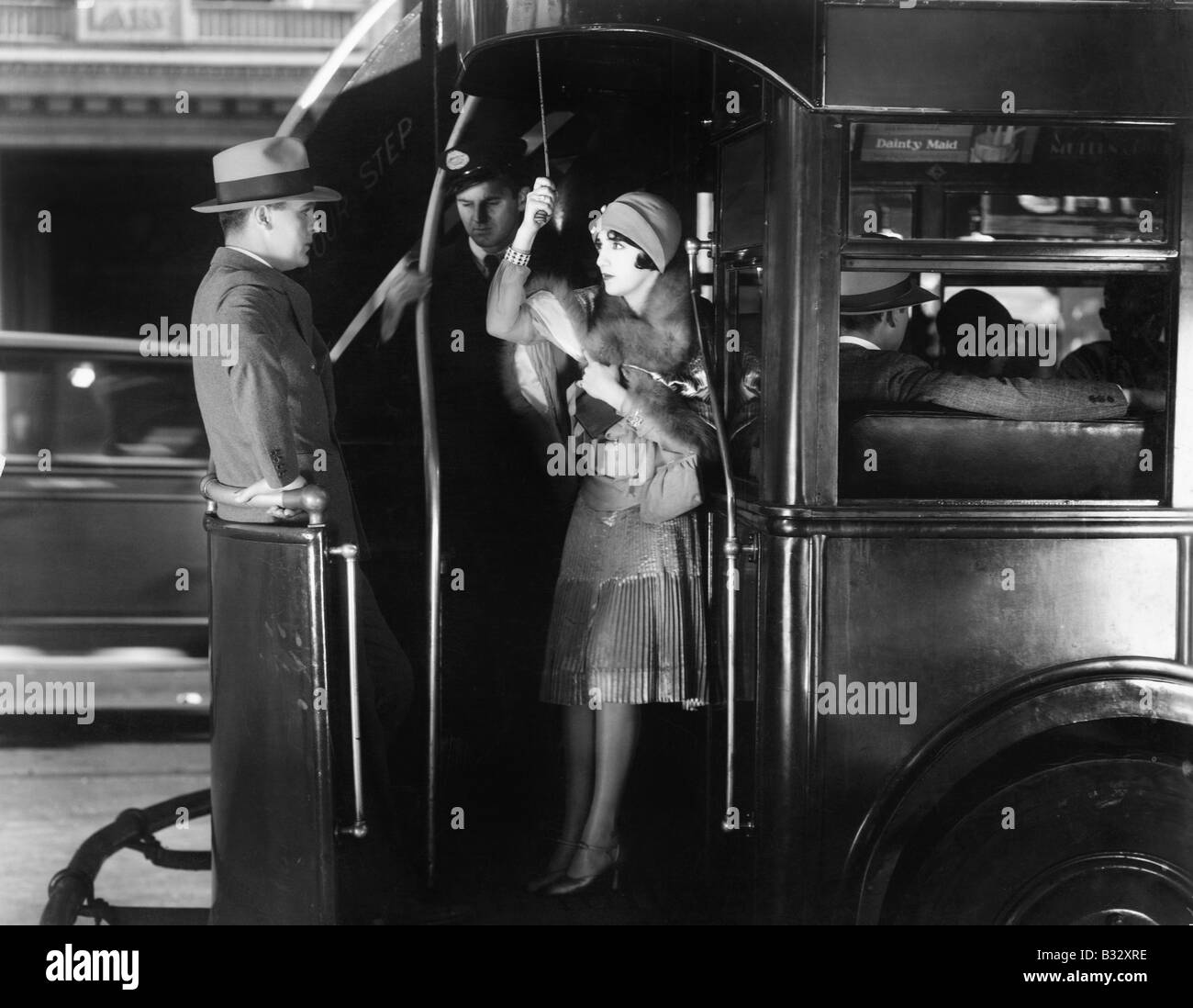 Young woman riding a bus flirting with a young man Stock Photo