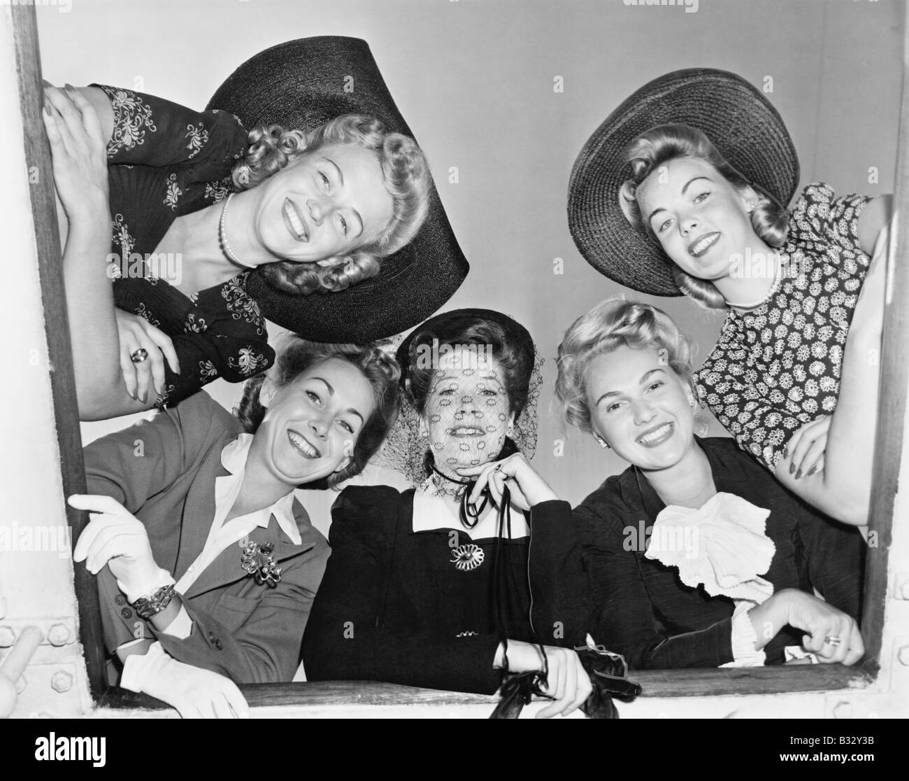 Group of women looking down from a ship Stock Photo