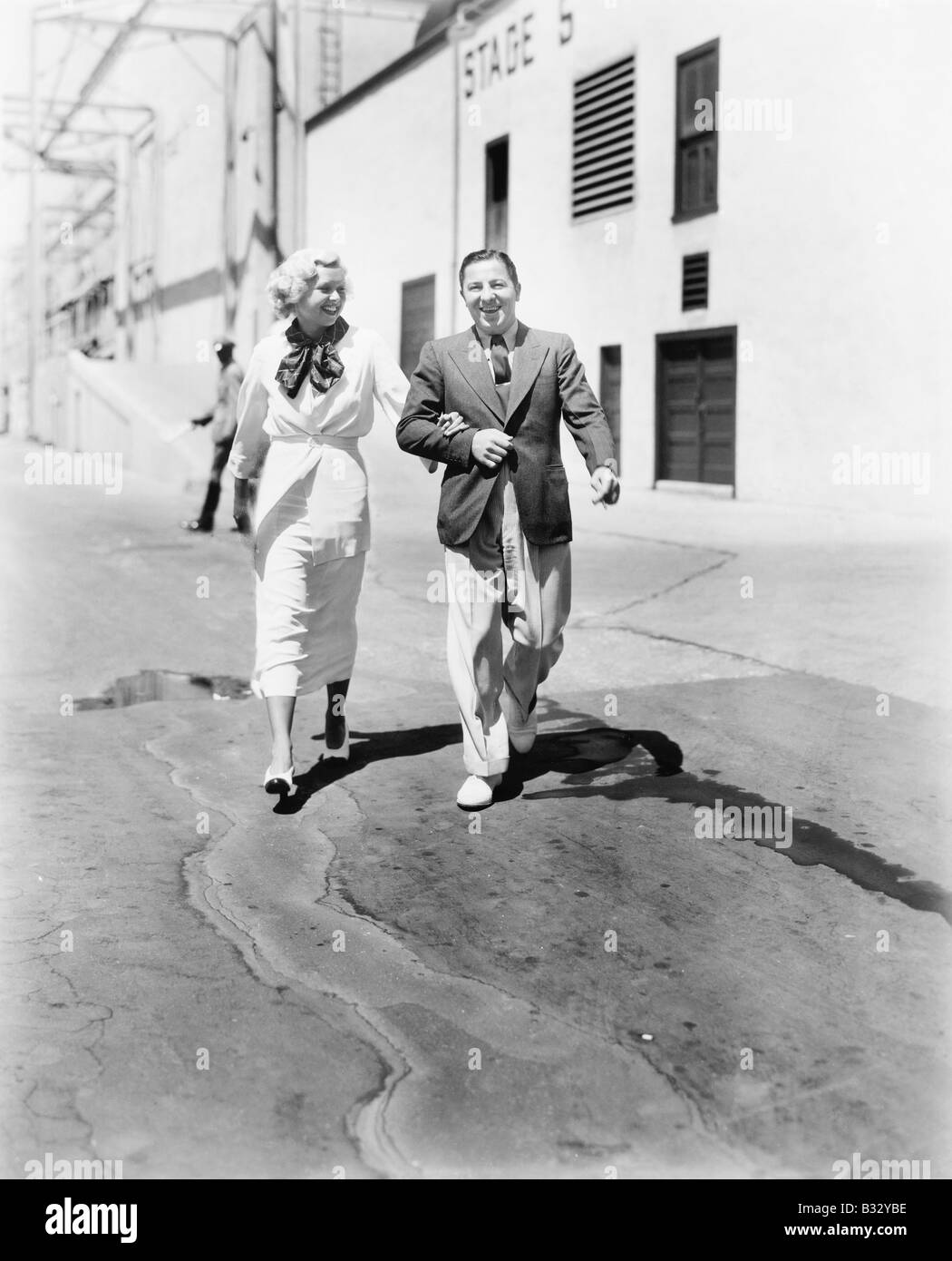 Two people walking together Black and White Stock Photos & Images - Alamy