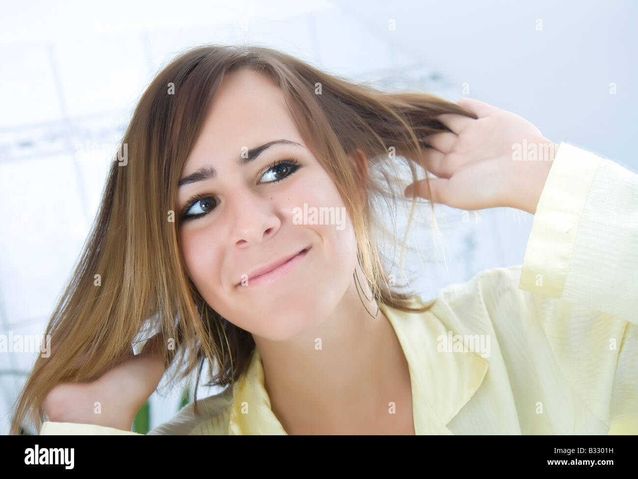 girl running her fingers through her hair Stock Photo Alamy