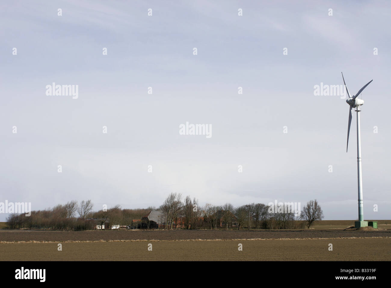 farm, barnyard with wind power station Stock Photo